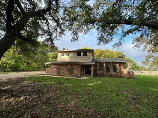 a view of a house with a yard balcony and sitting area