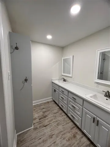 a spacious bathroom with a double vanity sink and a mirror