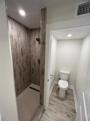 a bathroom with a toilet a sink and shower
