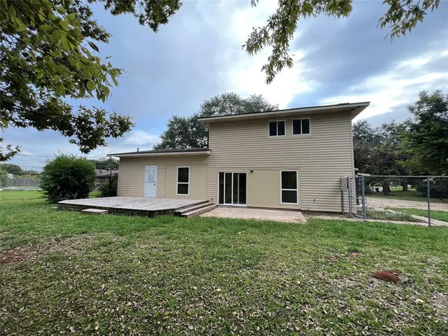 a front view of house with yard and trees