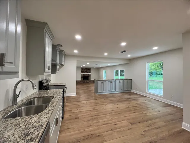 a view of kitchen with sink and refrigerator