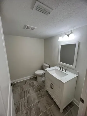a spacious bathroom with a double vanity sink mirror and toilet