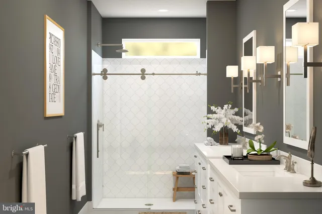 a bathroom with a sink vanity mirror and shower