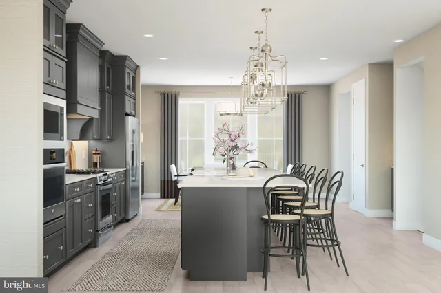 a kitchen with kitchen island a large counter top space appliances and cabinets