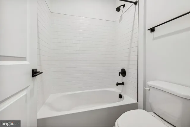 a bathroom with a toilet and a bathtub