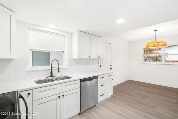 a kitchen with a sink cabinets and window
