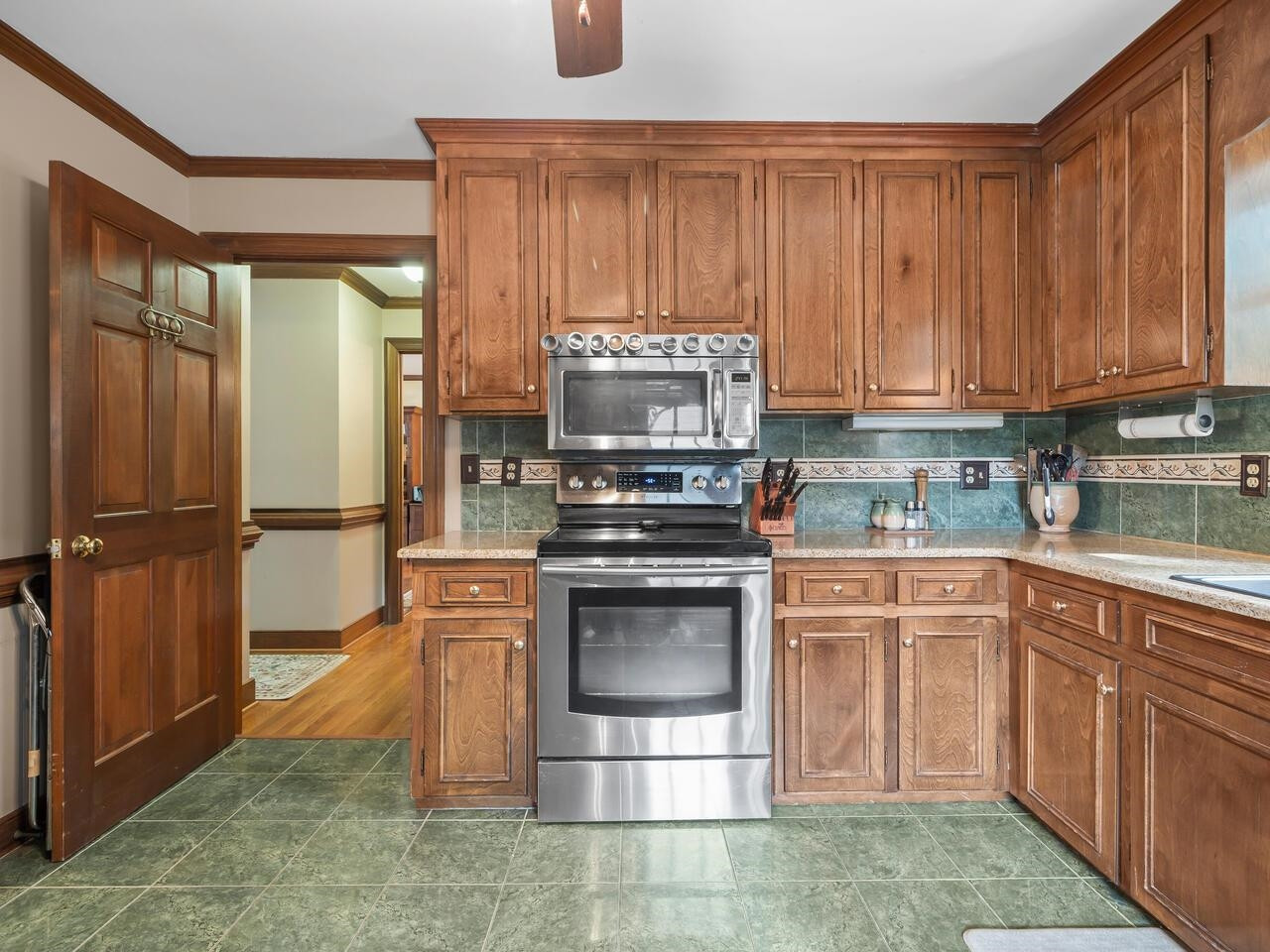 2603 Sawmill Road Raleigh, NC 27613 - Photo 12 of 53 a kitchen with stainless steel appliances granite countertop a stove a refrigerator and a sink
