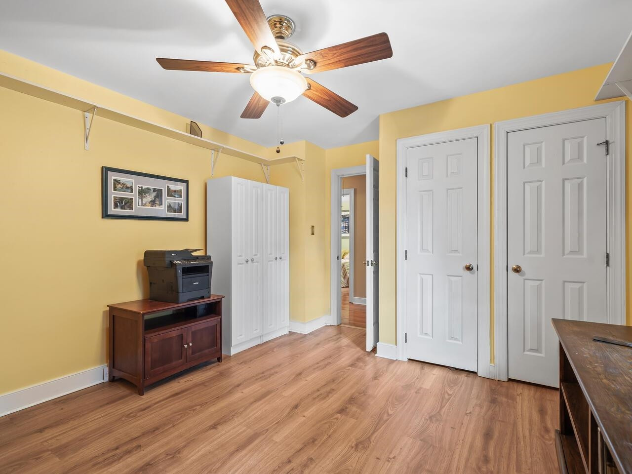 2603 Sawmill Road Raleigh, NC 27613 - Photo 24 of 53 a view of a workspace with wooden floor and ceiling fan