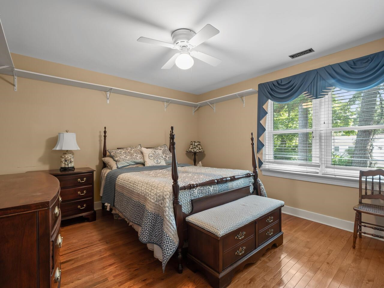 2603 Sawmill Road Raleigh, NC 27613 - Photo 25 of 53 a bedroom with a bed and a large window with wooden floor