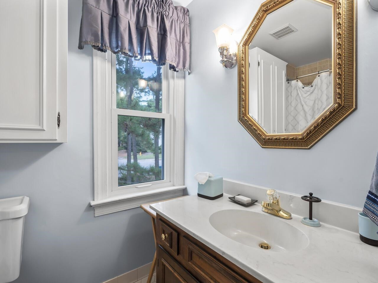 2603 Sawmill Road Raleigh, NC 27613 - Photo 28 of 53 a bathroom with a sink vanity and a mirror