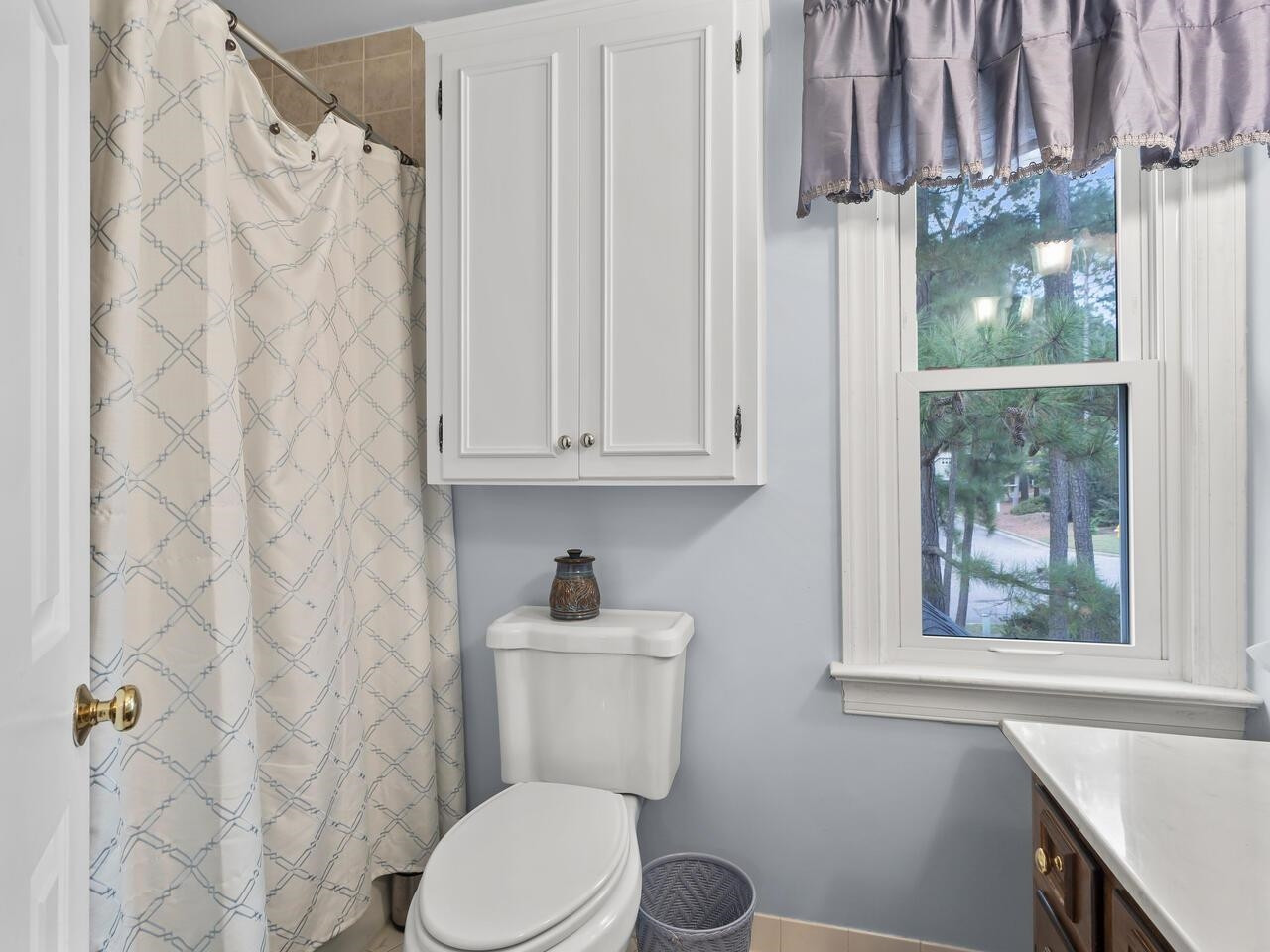 2603 Sawmill Road Raleigh, NC 27613 - Photo 29 of 53 a bathroom with a toilet a sink and a window