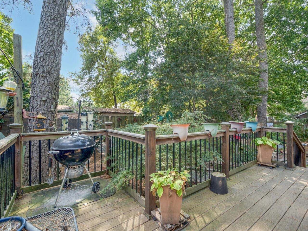 2603 Sawmill Road Raleigh, NC 27613 - Photo 40 of 53 a view of a deck with furniture and trees in the background