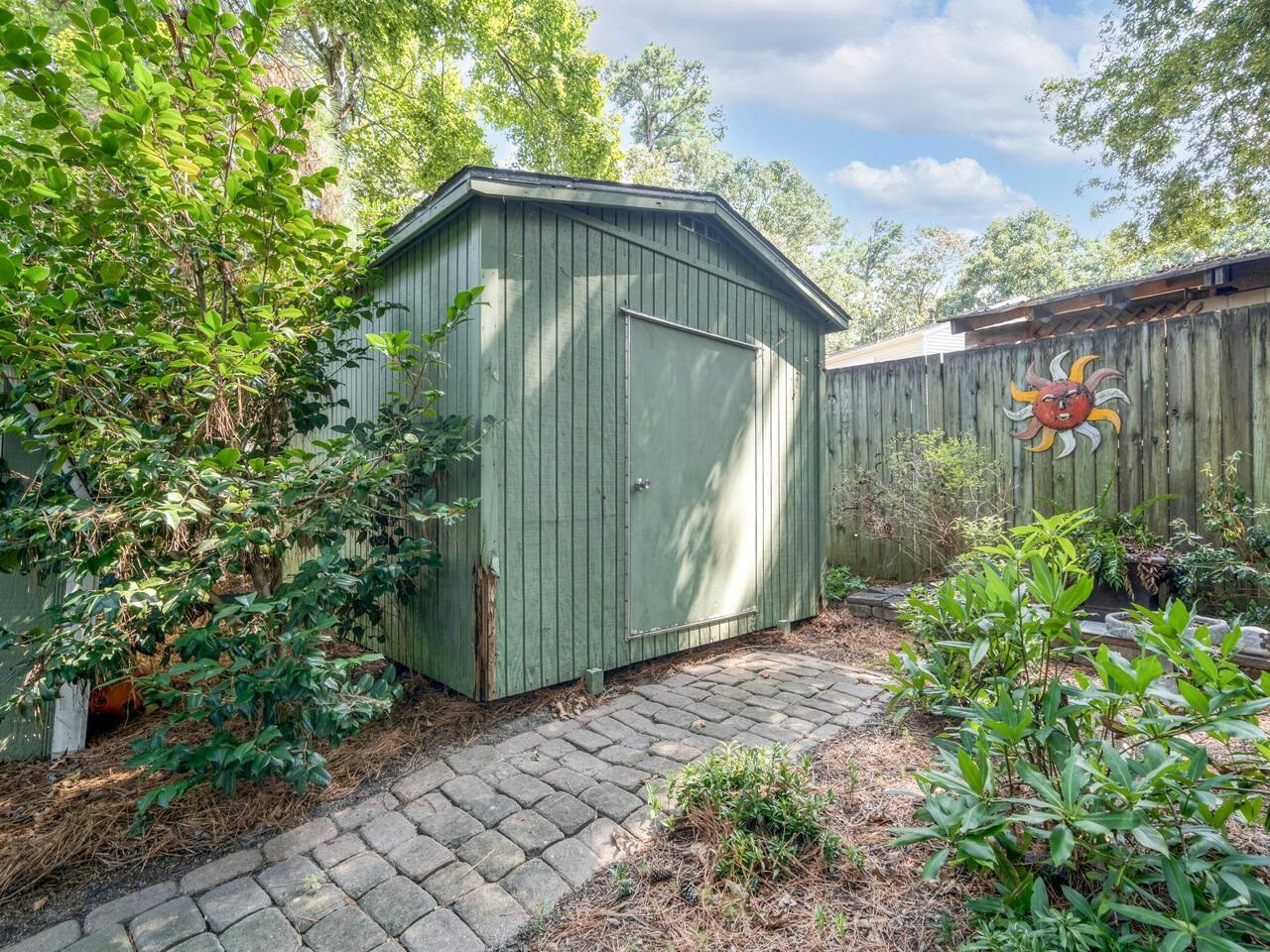 2603 Sawmill Road Raleigh, NC 27613 - Photo 49 of 53 a view of a wooden house with a small yard and a large trees