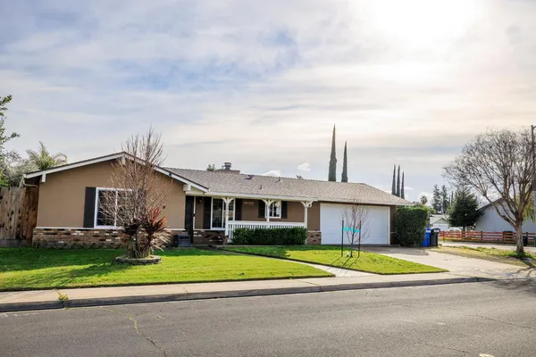 a front view of house with yard and green space