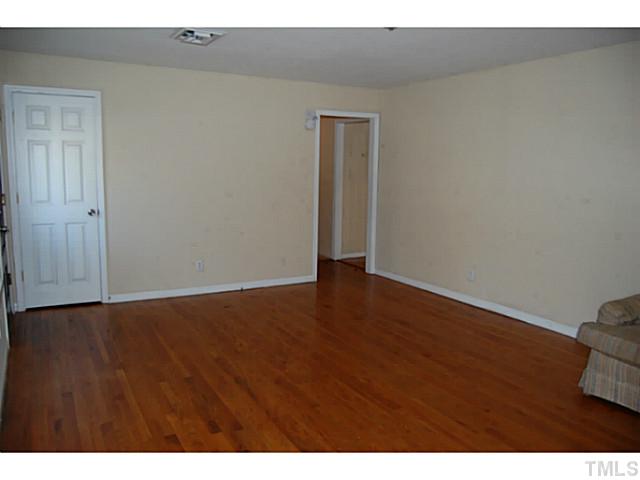 3204 Sanderford Road Raleigh, NC 27610 - Photo 4 of 15 a view of an empty room and wooden floor