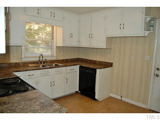 3204 Sanderford Road Raleigh, NC 27610 - Photo 9 of 15 a kitchen with a sink window and cabinets