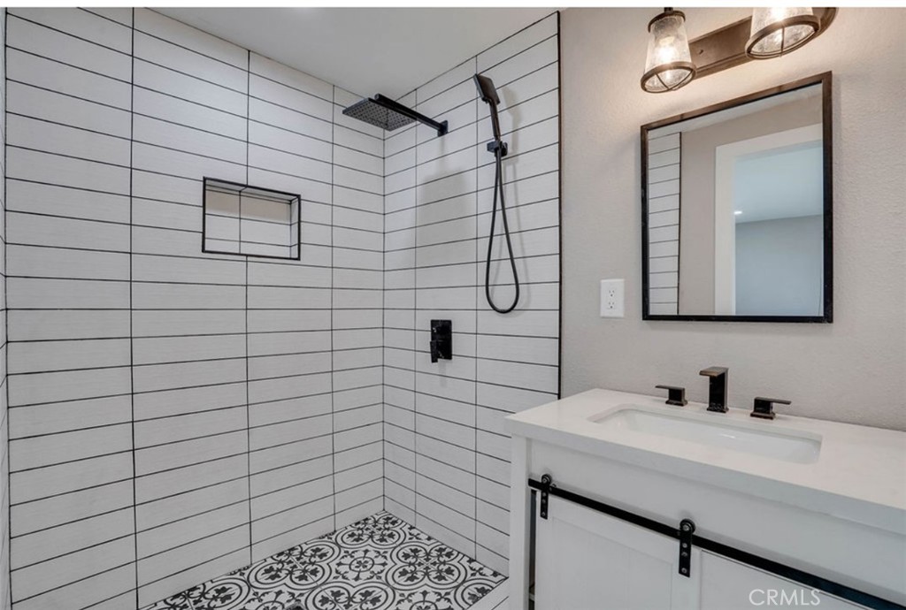 4141 California Norco, CA 92860 - Photo 11 of 28 a bathroom with a sink a mirror and shower