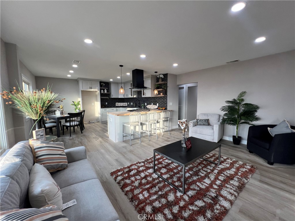 4141 California Norco, CA 92860 - Photo 15 of 28 a living room with furniture a chandelier and a dining room