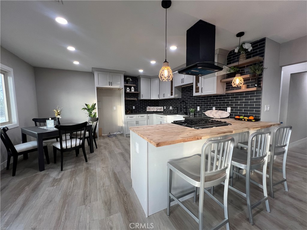 4141 California Norco, CA 92860 - Photo 16 of 28 a kitchen with a dining table chairs and wooden floor