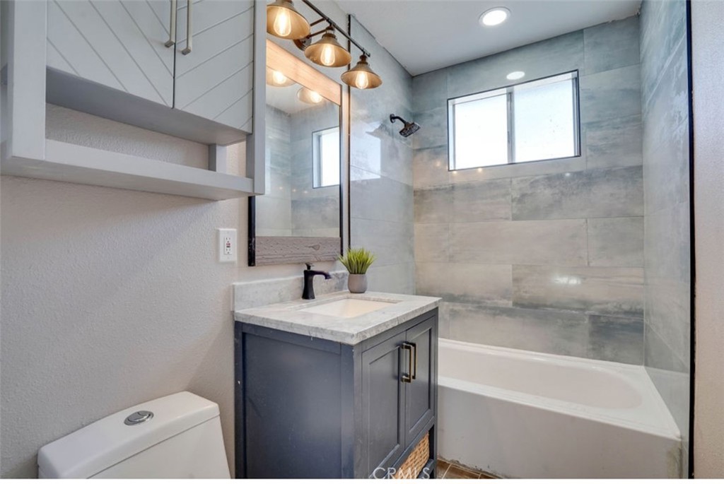 4141 California Norco, CA 92860 - Photo 19 of 28 a bathroom with a sink a toilet and bathtub