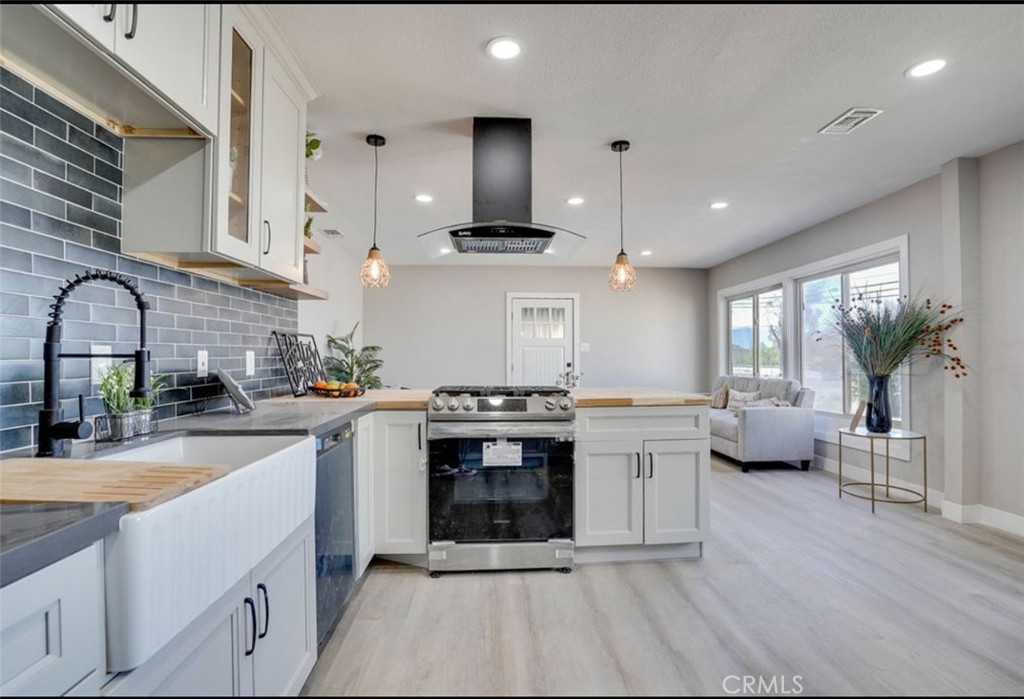4141 California Norco, CA 92860 - Photo 10 of 28 a kitchen with stainless steel appliances a stove a sink and white cabinets
