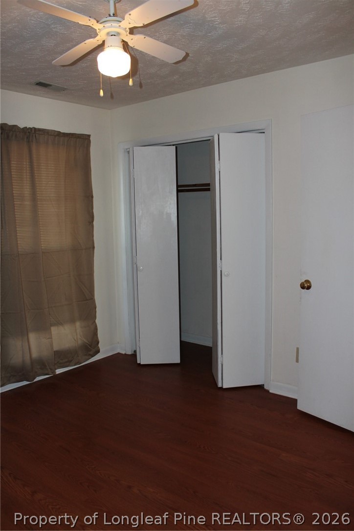 7805 Gallant Ridge Drive Fayetteville, NC 28314 - Photo 20 of 25 an empty room with wooden floor closet fan and windows