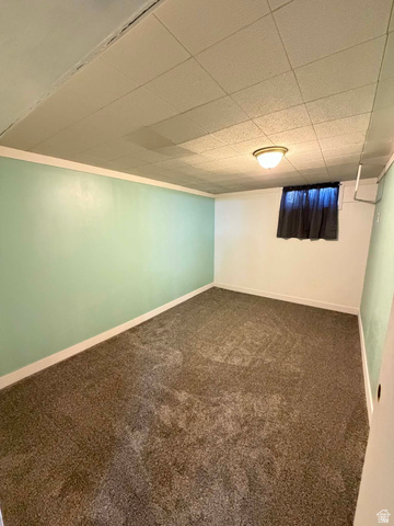 156 D Street Helper, UT 84526 - Photo 21 of 24 Finished below grade area featuring dark carpet and a drop ceiling