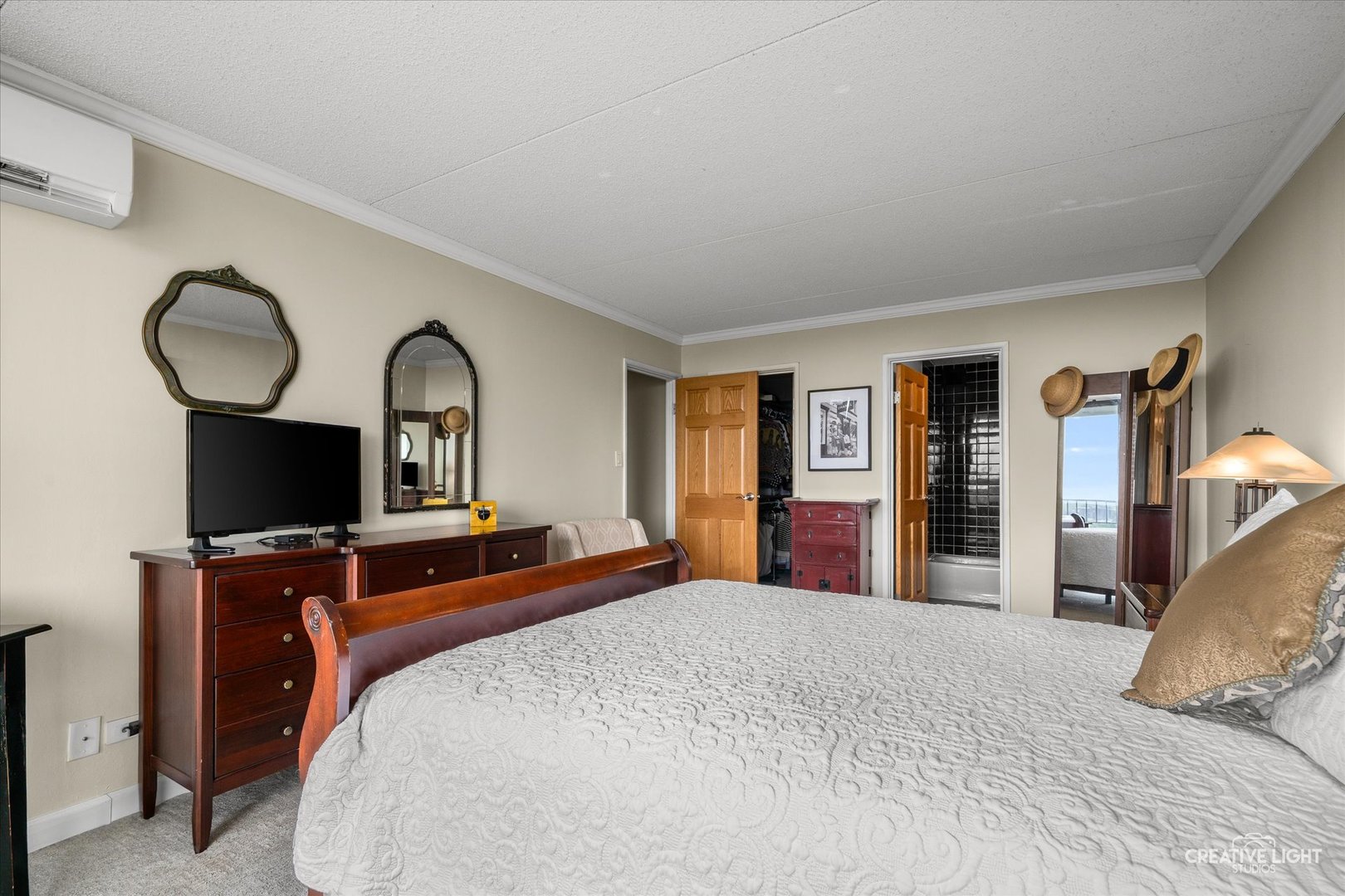 2005 South Finley Road, Unit 1209 Lombard, IL 60148 - Photo 12 of 29 a bedroom with a large bed and a flat tv screen on dresser