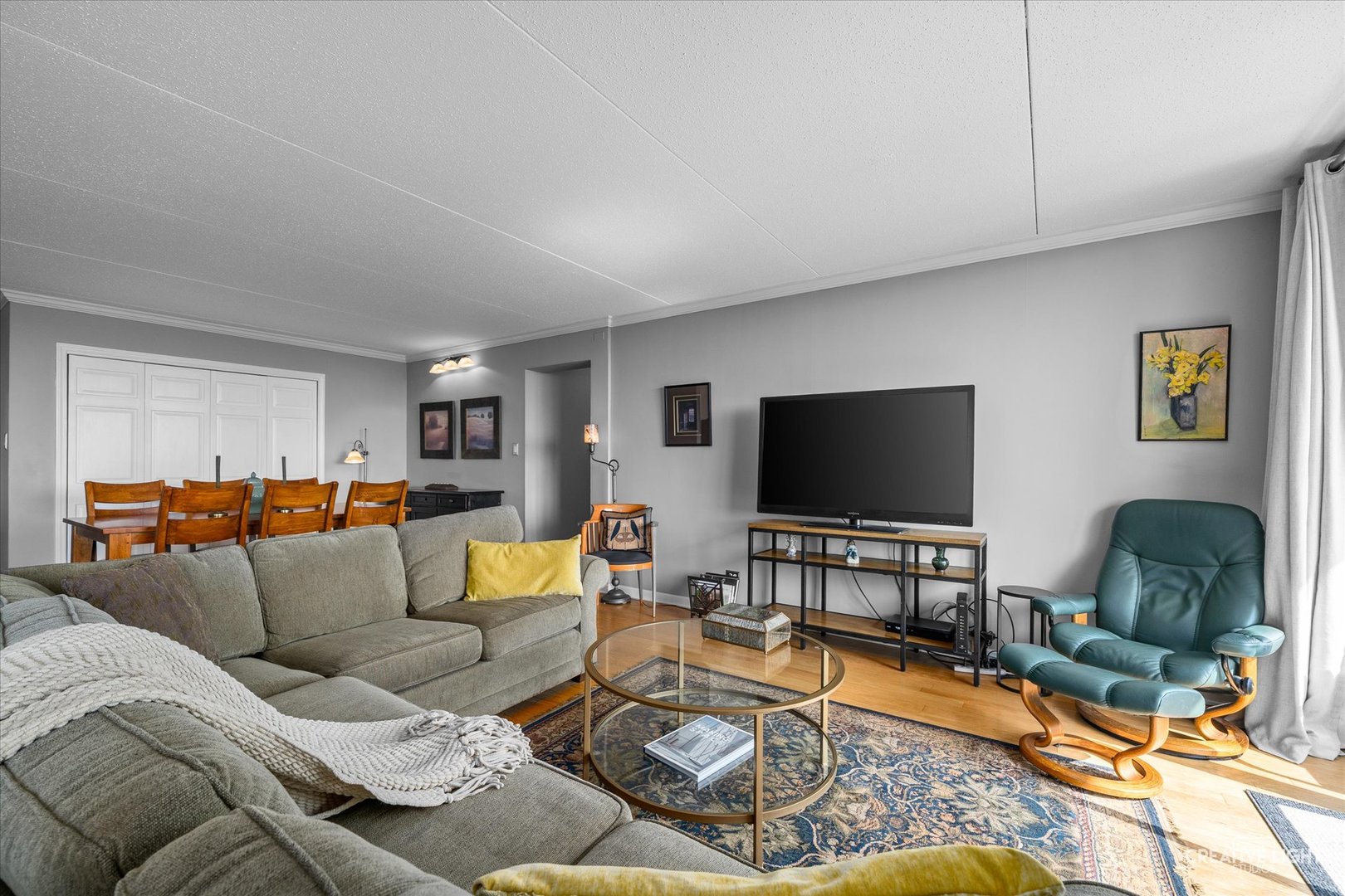 2005 South Finley Road, Unit 1209 Lombard, IL 60148 - Photo 3 of 29 a living room with furniture and a flat screen tv