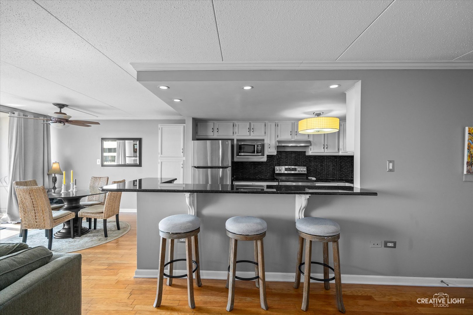 2005 South Finley Road, Unit 1209 Lombard, IL 60148 - Photo 7 of 29 a kitchen with stainless steel appliances a dining table chairs and a refrigerator