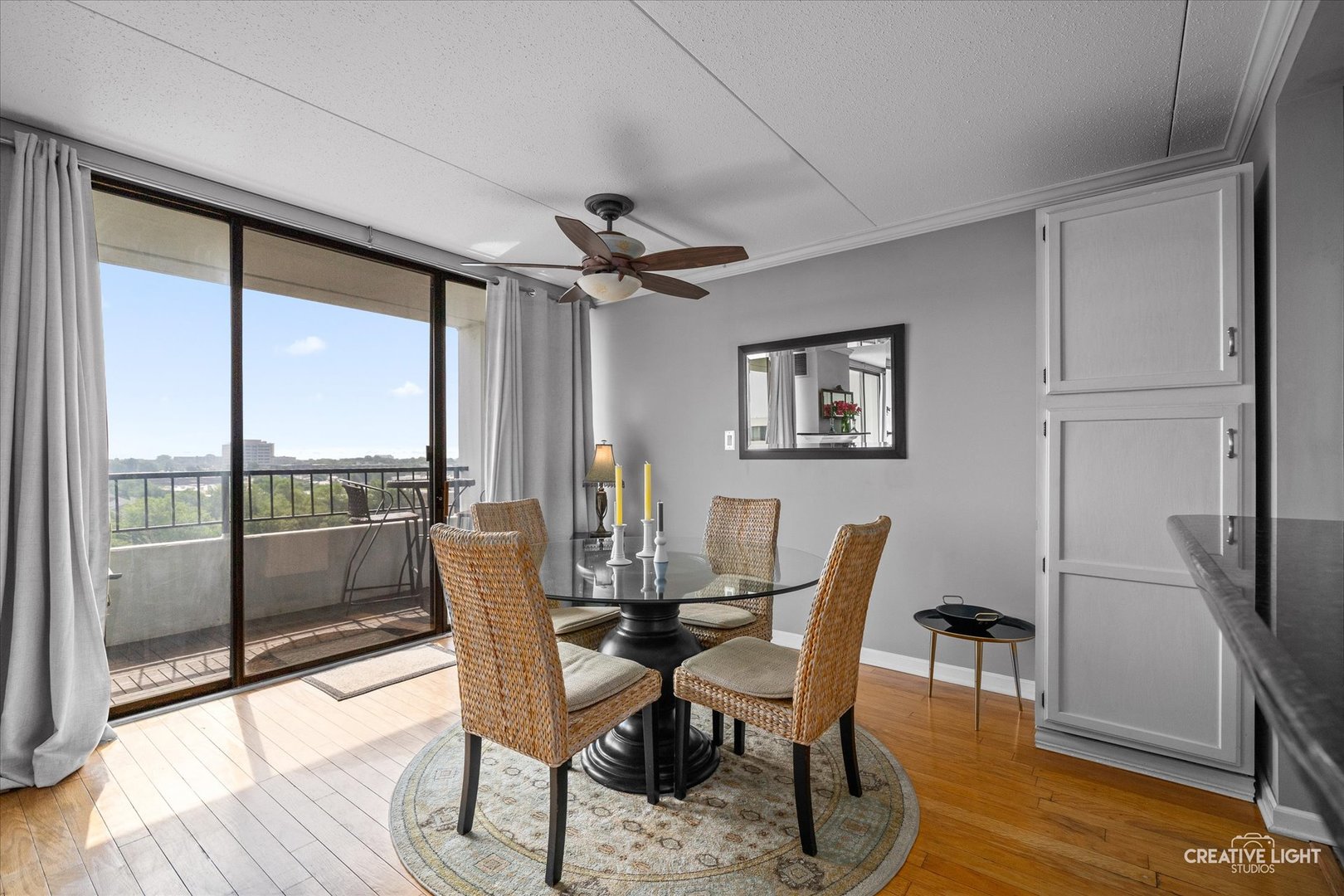 2005 South Finley Road, Unit 1209 Lombard, IL 60148 - Photo 9 of 29 a dining room with furniture a floor to ceiling window and wooden floor