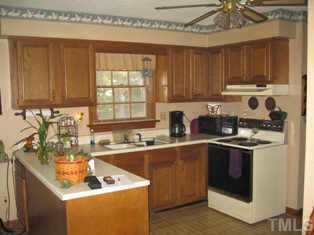 8301 Bellingham Circle Raleigh, NC 27615 - Photo 3 of 11 a kitchen with a sink stove and cabinets