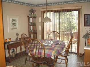 8301 Bellingham Circle Raleigh, NC 27615 - Photo 4 of 11 a view of a dining room with furniture window and wooden floor