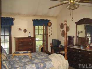 8301 Bellingham Circle Raleigh, NC 27615 - Photo 5 of 11 a bedroom with a bed dresser and a window