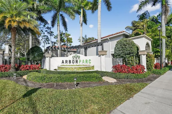 a front view of a house with a yard and fountain