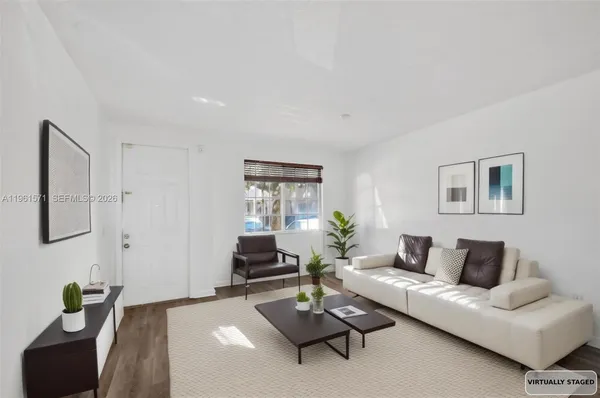 a view of a dining room with furniture and a potted plant