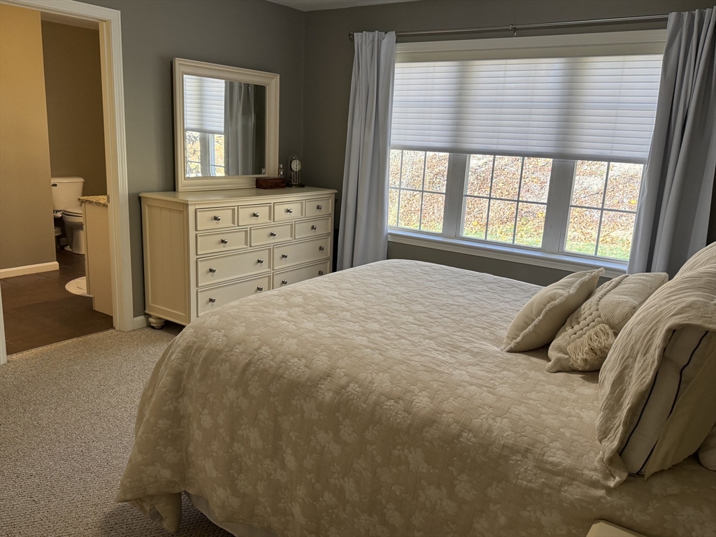 2 Riley Road, Unit B Lunenburg, MA 01462 - Photo 17 of 25 a large bed sitting in a bedroom next to a window and dresser