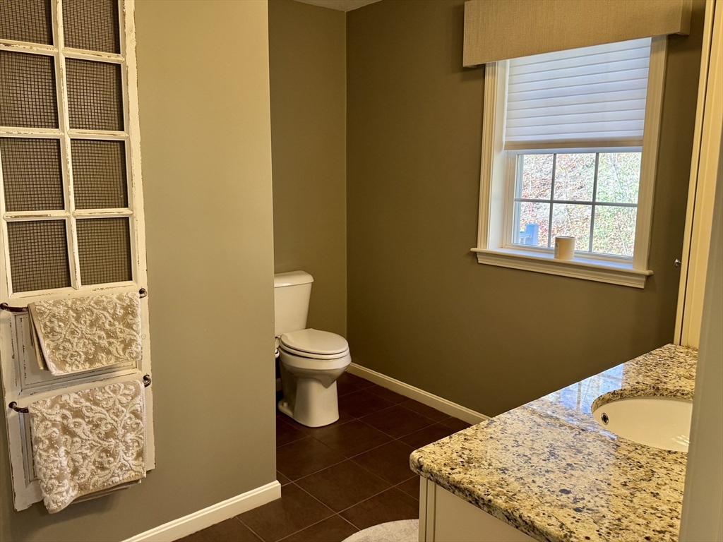 2 Riley Road, Unit B Lunenburg, MA 01462 - Photo 18 of 25 a bathroom with a granite countertop sink and a toilet