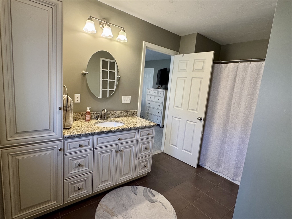 2 Riley Road, Unit B Lunenburg, MA 01462 - Photo 19 of 25 a spacious bathroom with a double vanity sink and a mirror