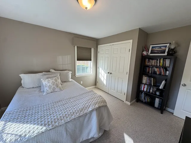 a bedroom with a bed a dresser and a book shelf