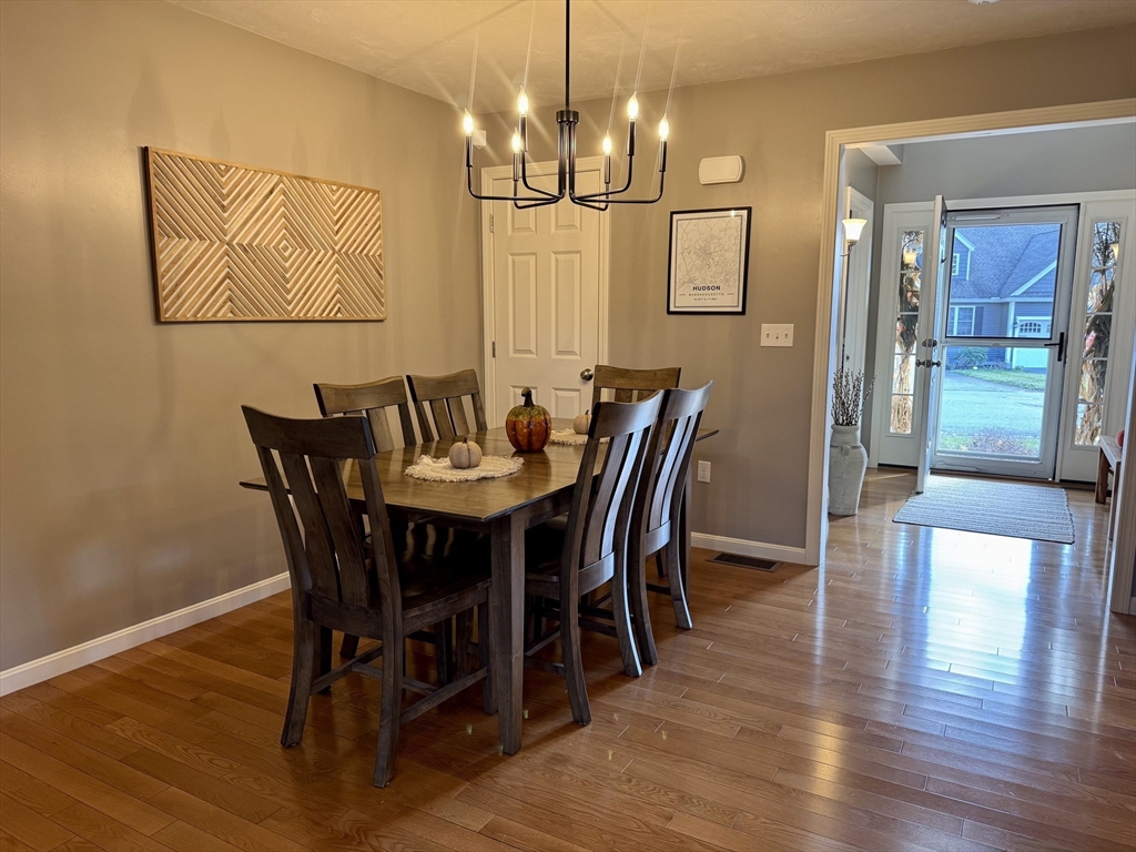 2 Riley Road, Unit B Lunenburg, MA 01462 - Photo 3 of 25 a view of a dining room with furniture wooden floor and chandelier