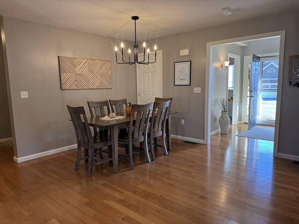 2 Riley Road, Unit B Lunenburg, MA 01462 - Photo 6 of 25 a view of a dining room with furniture wooden floor and chandelier