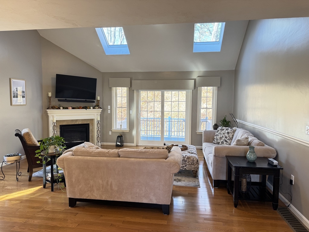 2 Riley Road, Unit B Lunenburg, MA 01462 - Photo 10 of 25 a living room with furniture a flat screen tv and a fireplace