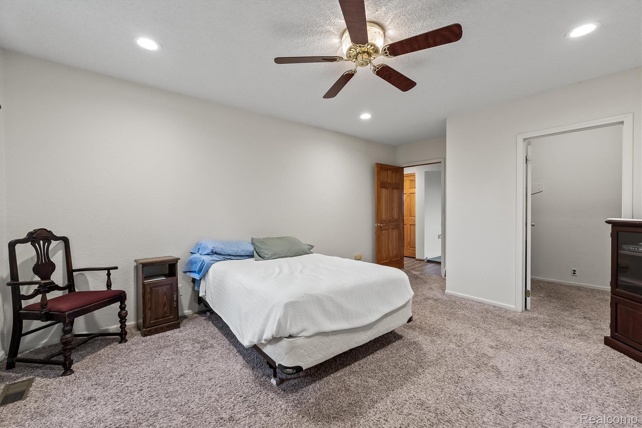3553 North State Road Owosso, MI 48867 - Photo 26 of 45 Recessed lighting, ceiling fan, and light-toned walls with carpeted flooring