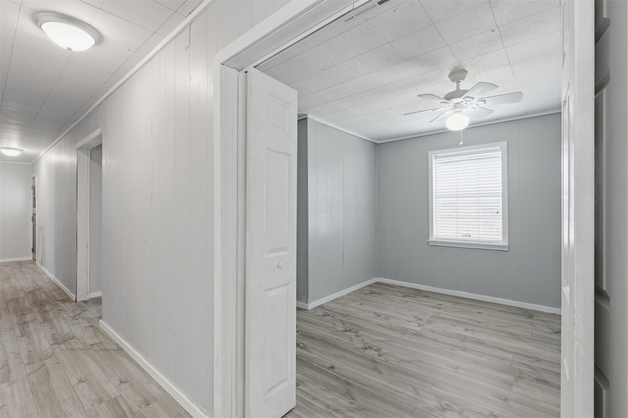 1310 Brazos Street Hempstead, TX 77445 - Photo 14 of 32 a view of an empty room with wooden floor and a window