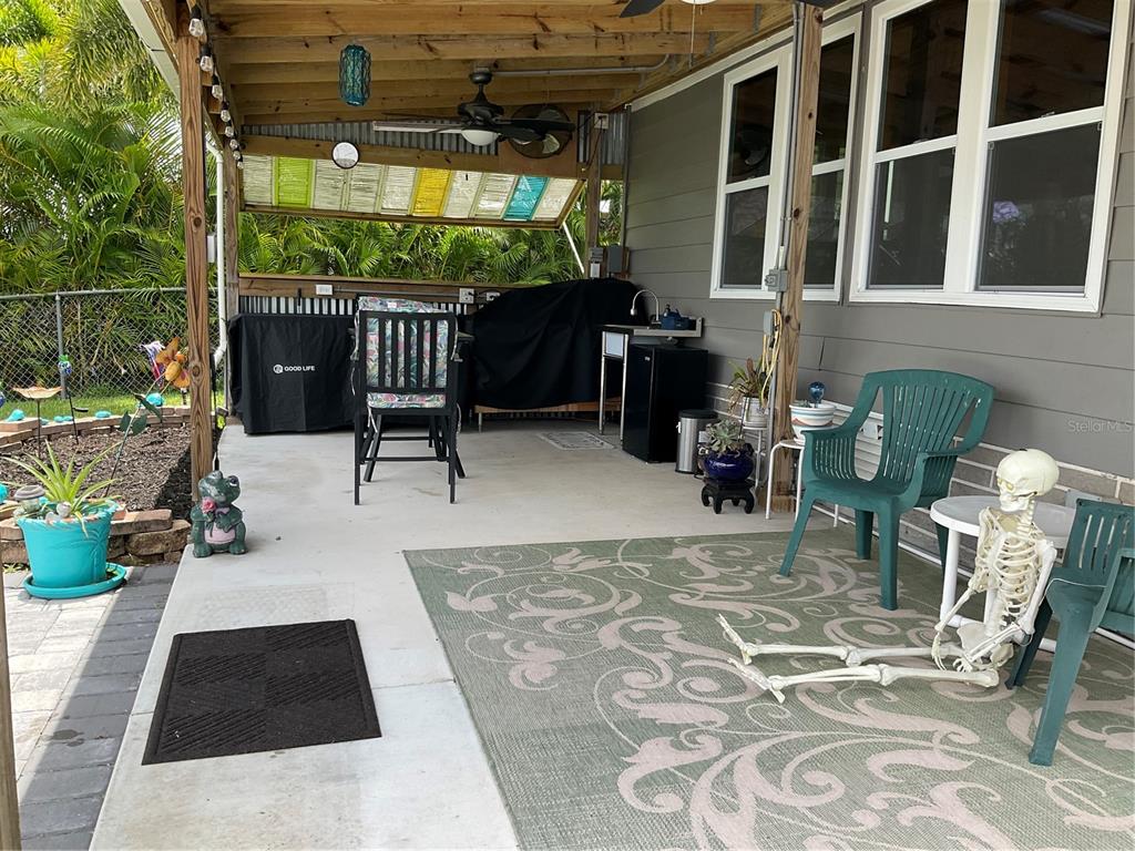 1558 Chobee Street Okeechobee, FL 34974 - Photo 17 of 63 a view of a chairs and table in backyard