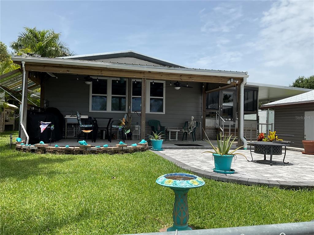 1558 Chobee Street Okeechobee, FL 34974 - Photo 2 of 63 a view of a house with backyard sitting area and swimming pool