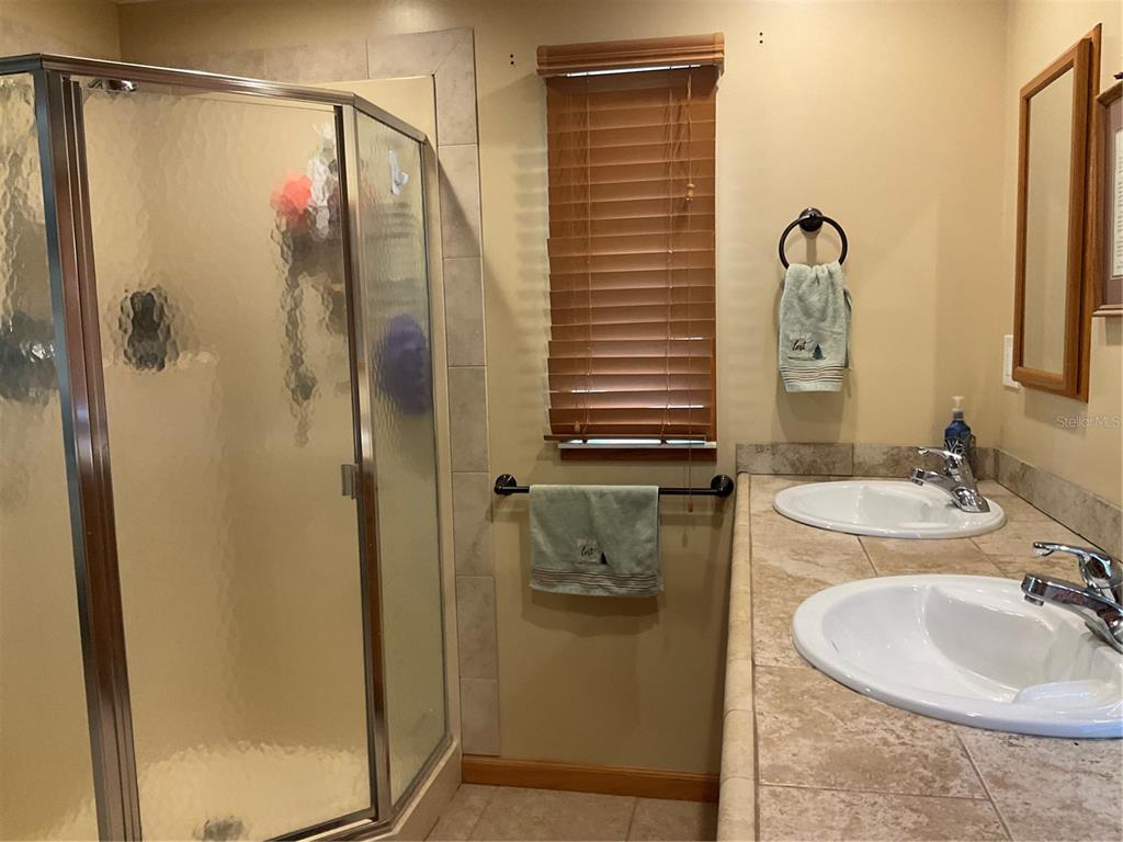 1558 Chobee Street Okeechobee, FL 34974 - Photo 26 of 63 a bathroom with a sink and mirror