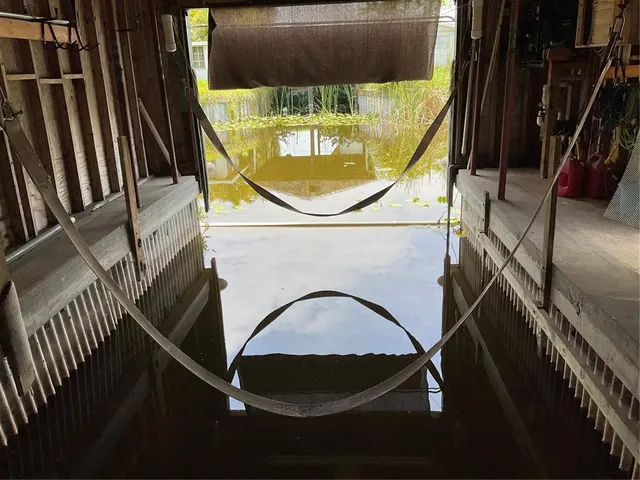 a kitchen with granite countertop a stove top oven microwave and cabinets