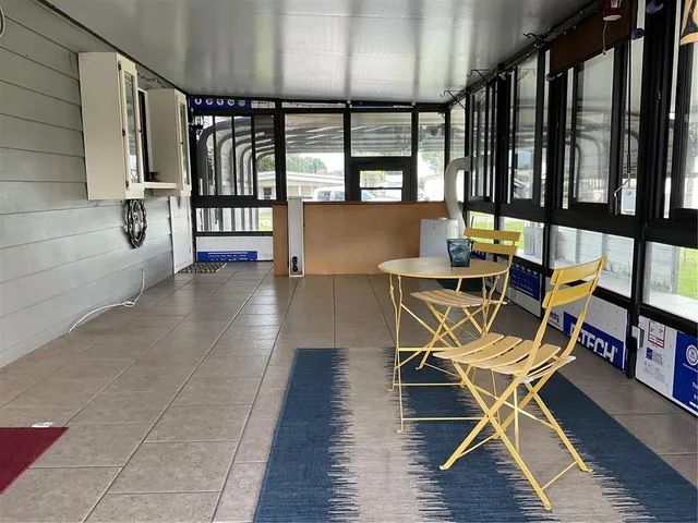 a view of a patio with a table chairs and a backyard